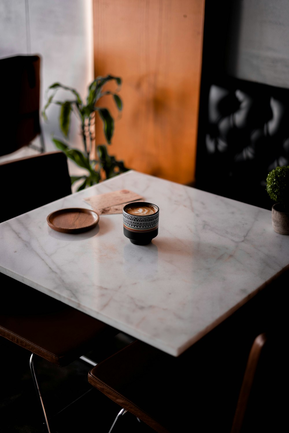 black and white ceramic mugs on brown wooden table