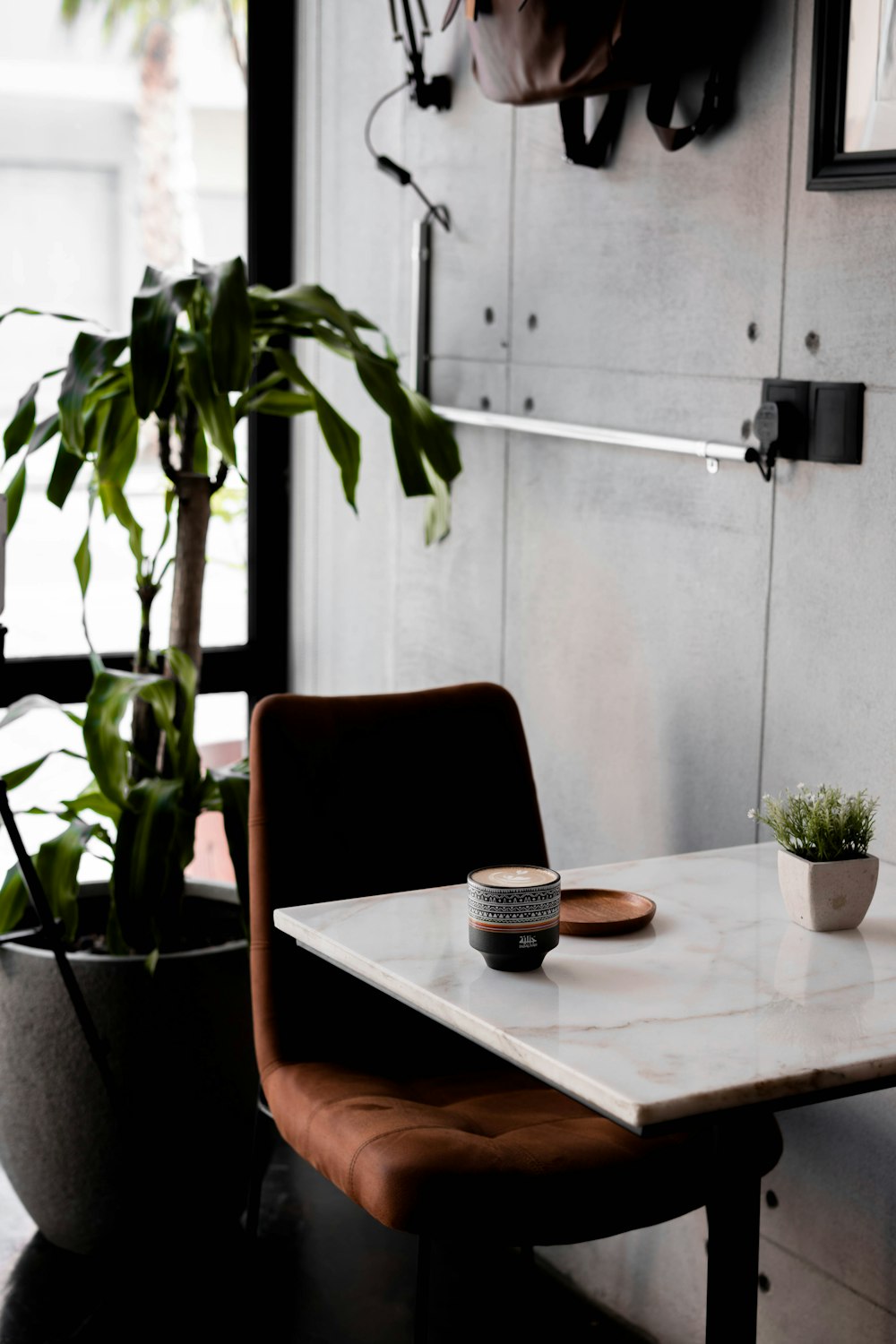 brown wooden table with white ceramic plate and brown chair