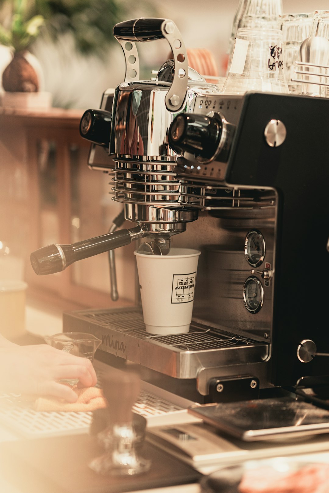 white ceramic mug on silver espresso machine