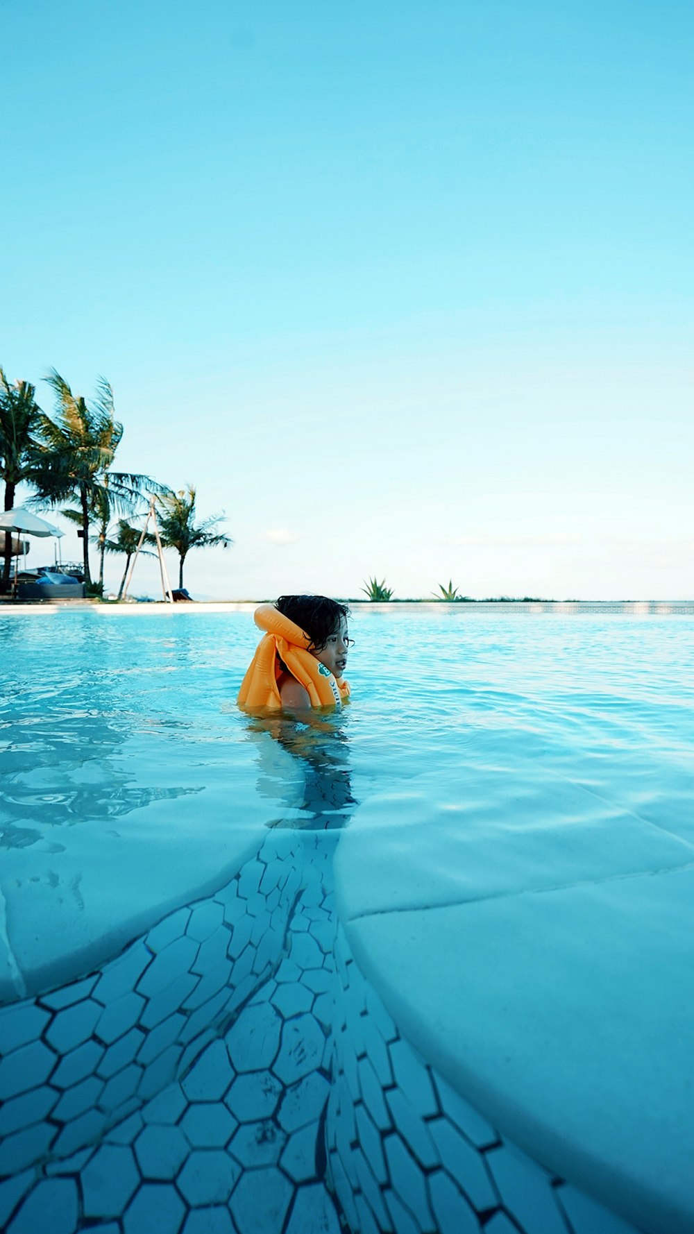 woman in swimming pool during daytime