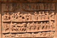 An ancient stone carving depicting scenes from monastic life, reflecting Vinaya teachings.
