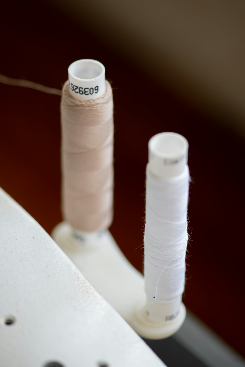 white thread on white plastic table