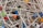 A tangled collection of metallic sewing pins with colorful, round plastic heads in various shades like black, red, blue, yellow, and green.