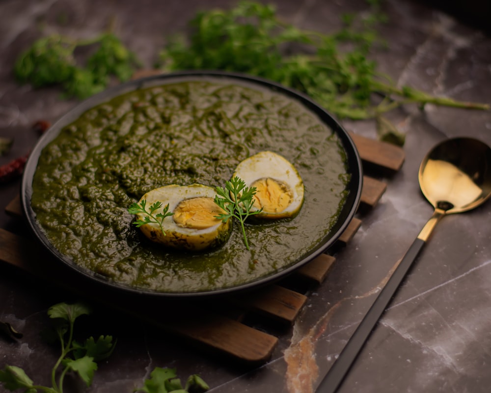 green vegetable on black ceramic plate