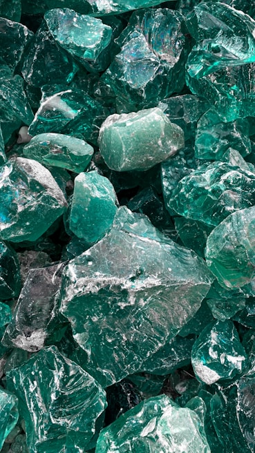 A cluster of raw emerald stones showcasing their natural green hues and textures