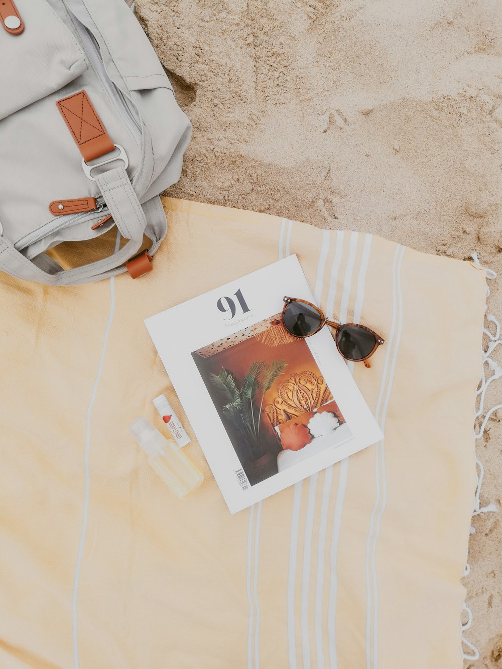 white leather handbag on white textile