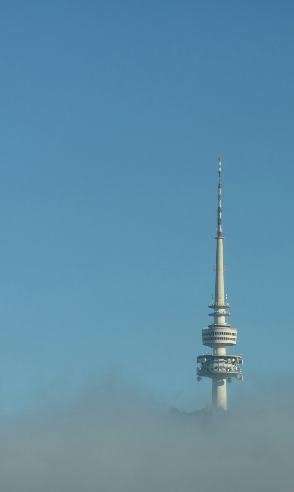 Torre de hormigón blanco y negro bajo el cielo azul durante el día