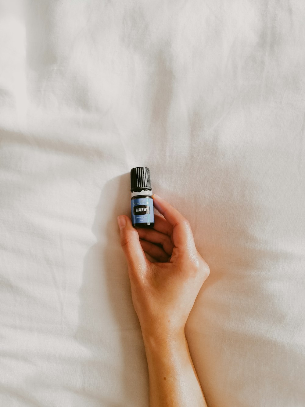 person holding black and silver bottle