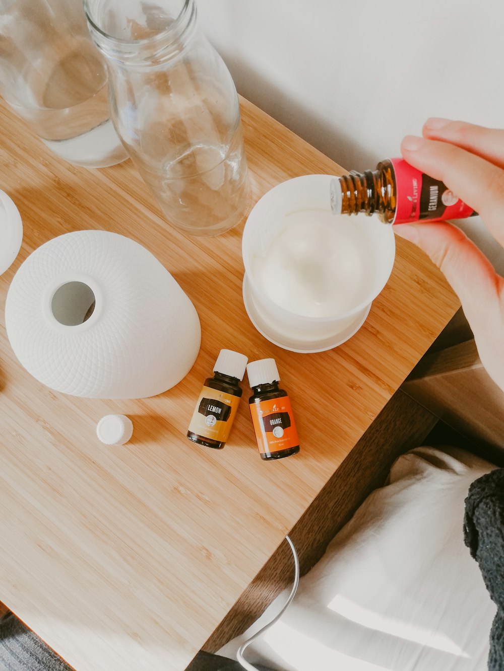 person holding white and orange bottle