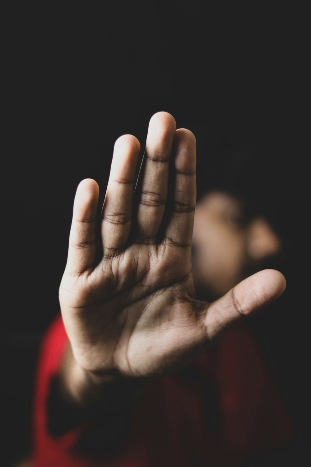 persons left hand on black background