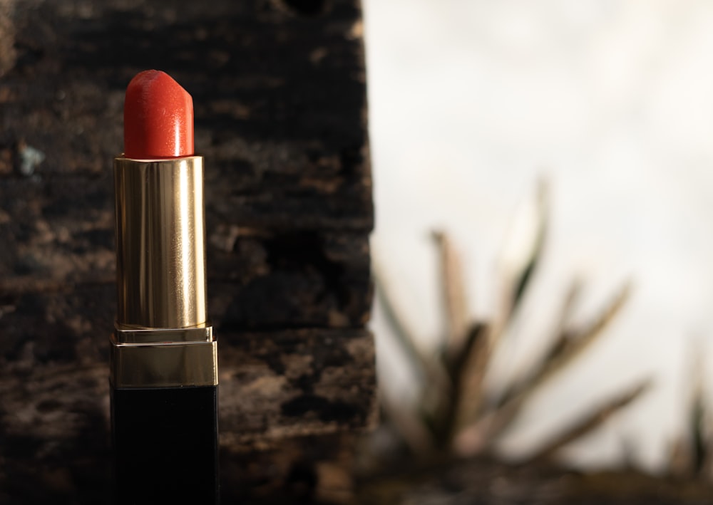 red lipstick on brown wooden table