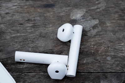 Close-up of Neofren wireless earbuds resting on a wooden table