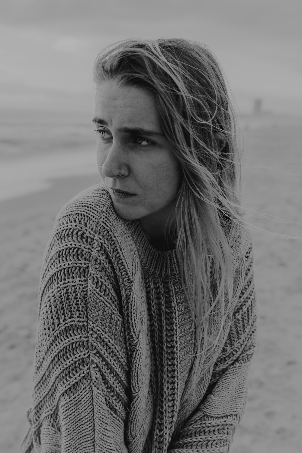 grayscale photo of woman in knit sweater