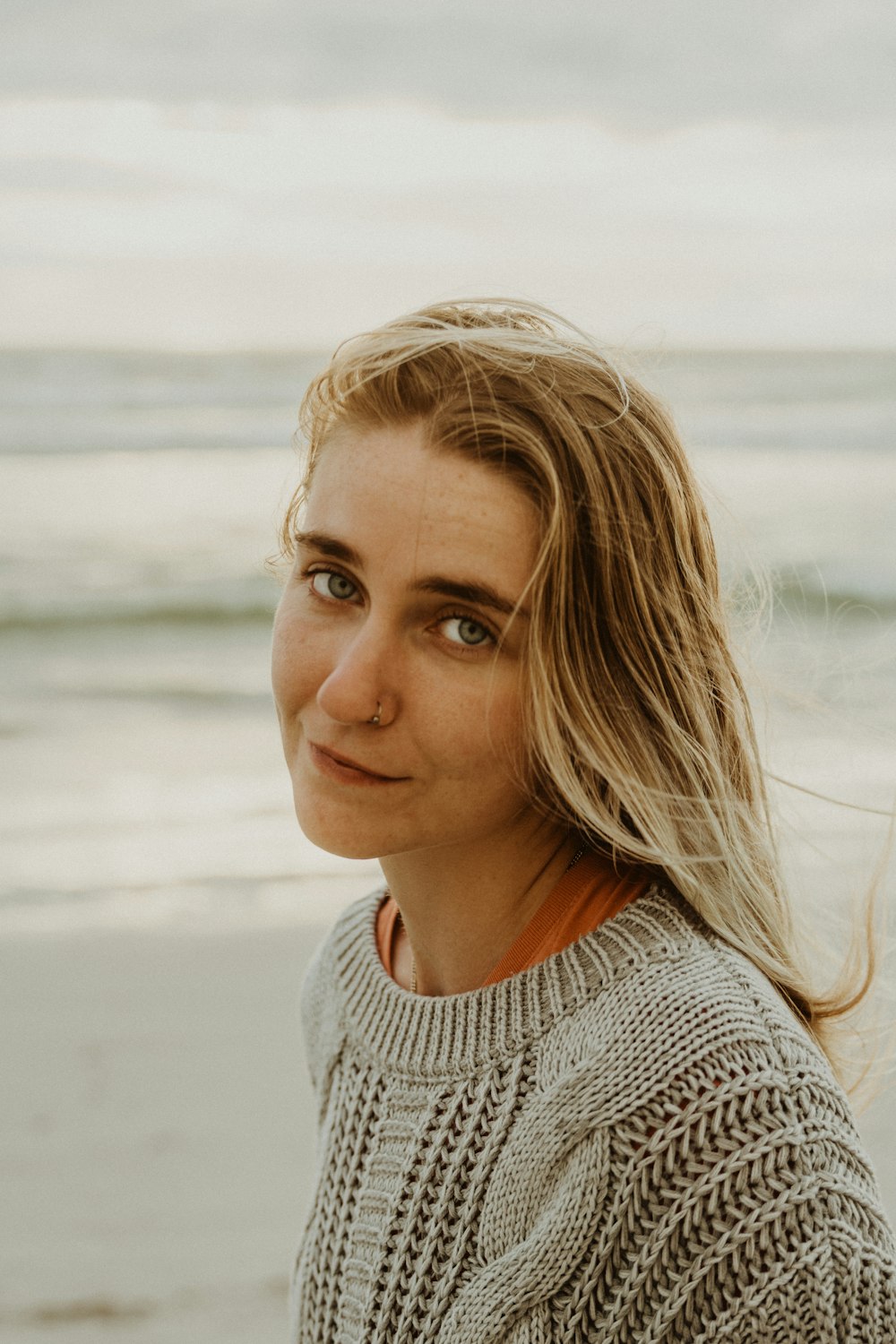 woman in gray knit shirt smiling