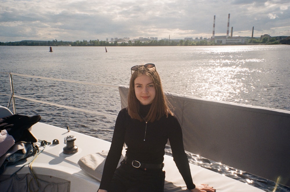 woman in black long sleeve shirt standing on dock during daytime