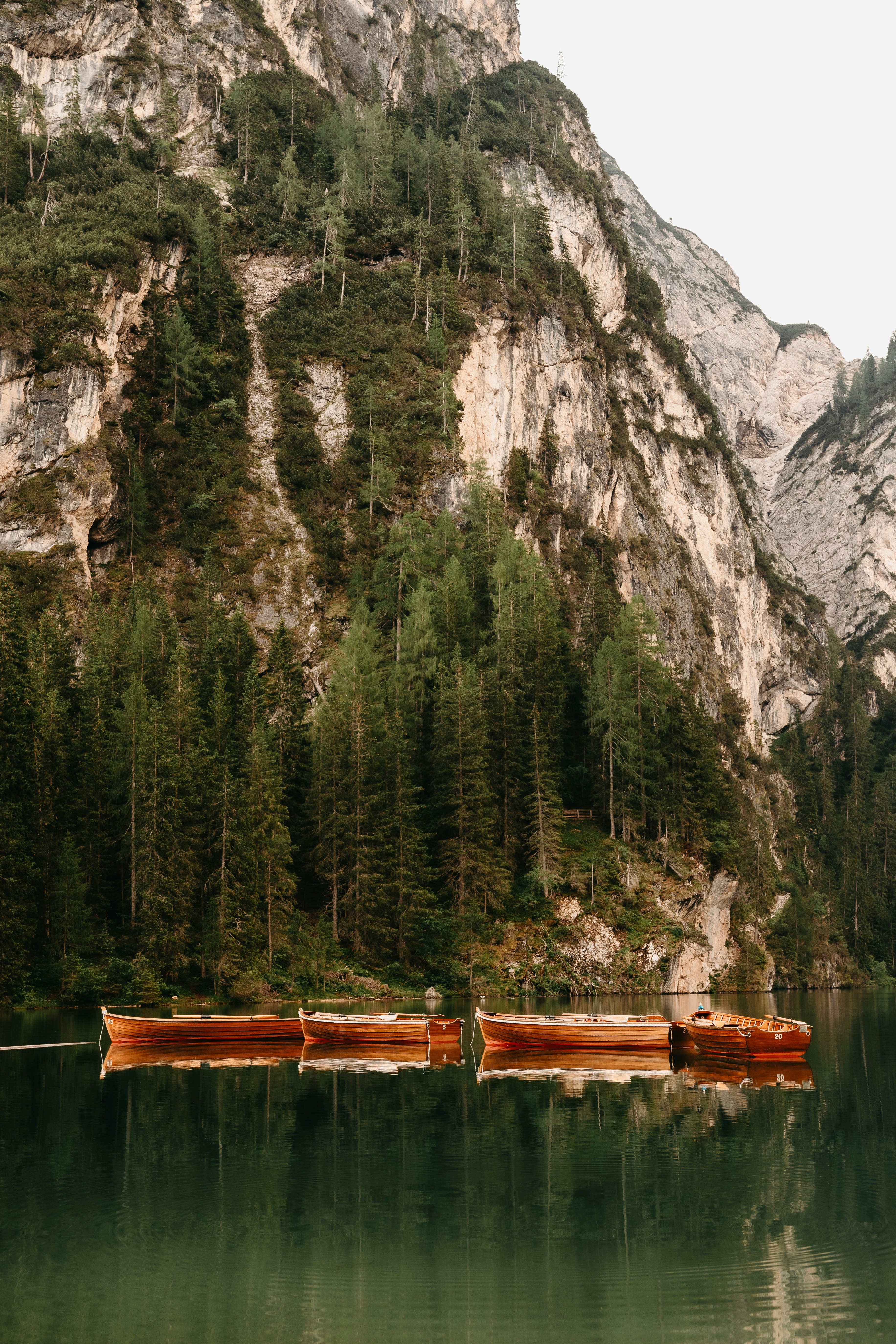Brown wooden boat on lake near mountain during daytime photo – Free ...