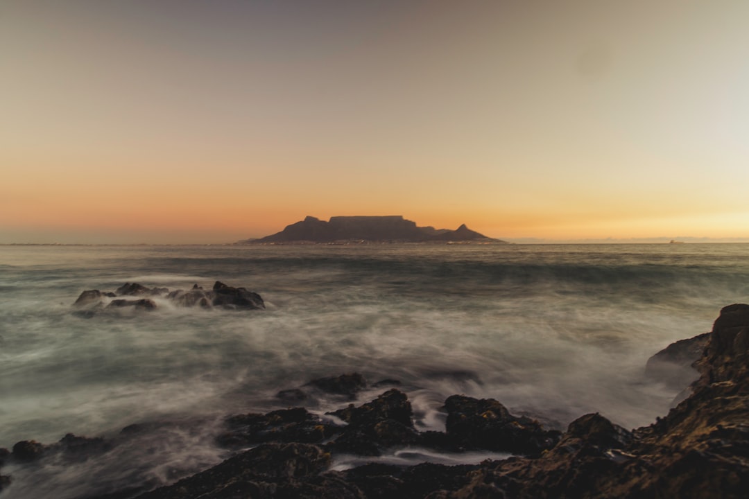 ocean waves crashing on rocks during sunset