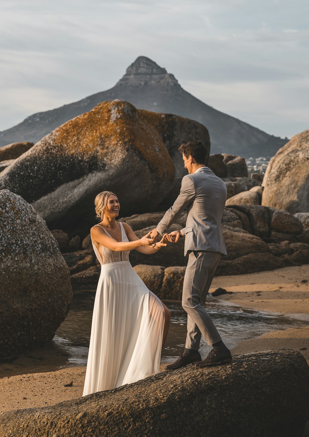 man and woman kissing on beach during daytime