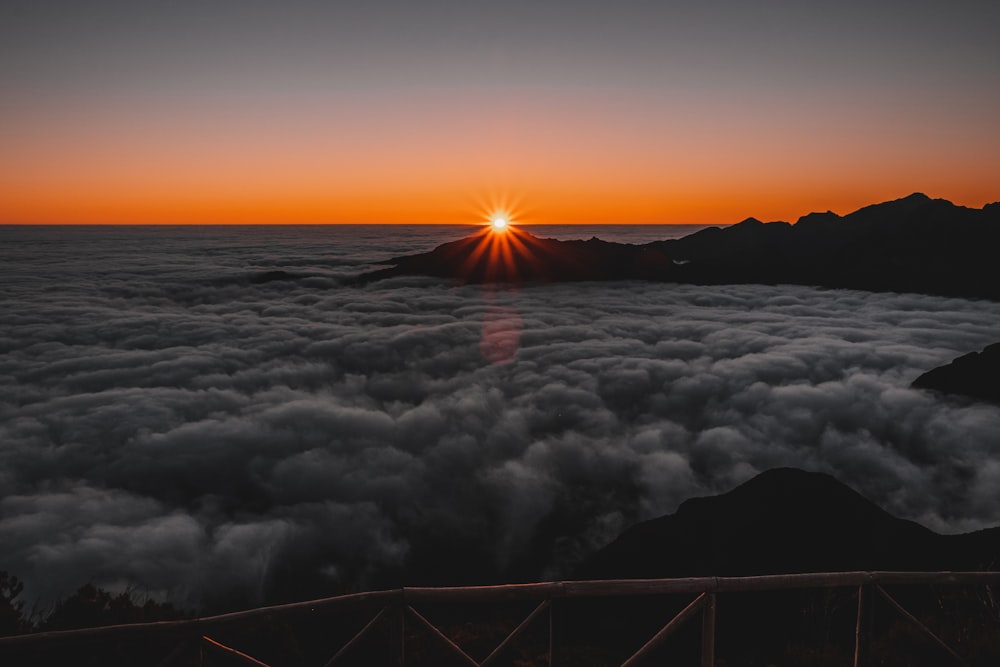 clouds on top of mountain during sunset