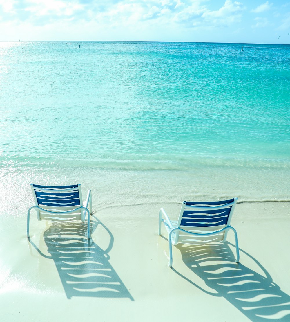 white and blue striped lounge chair on beach