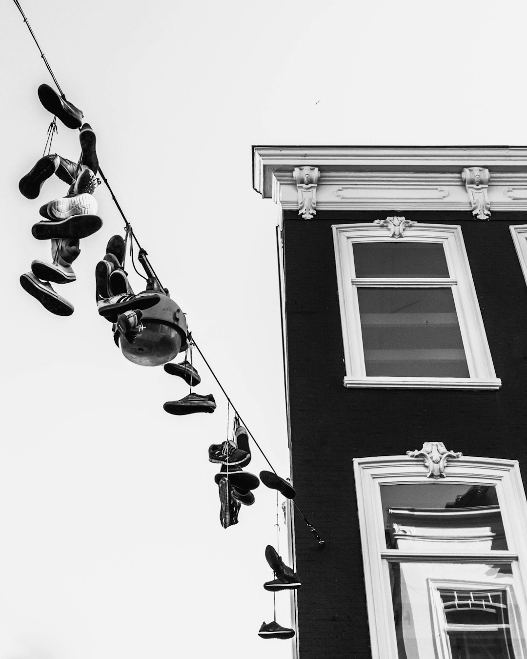 grayscale photo of hanging clothes on rope