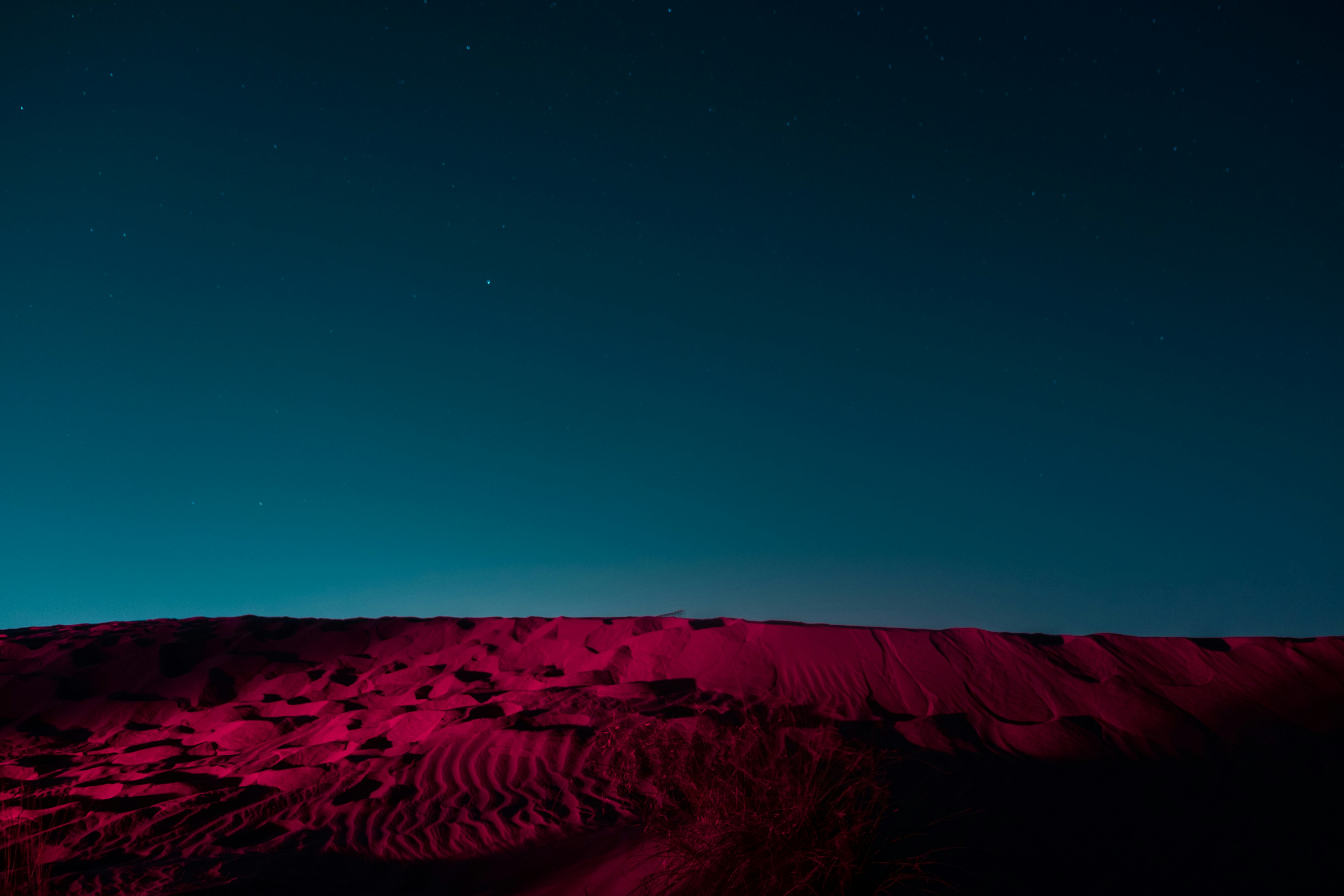 brown sand under blue sky during night time