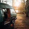 gray van parked on brown dirt road during daytime