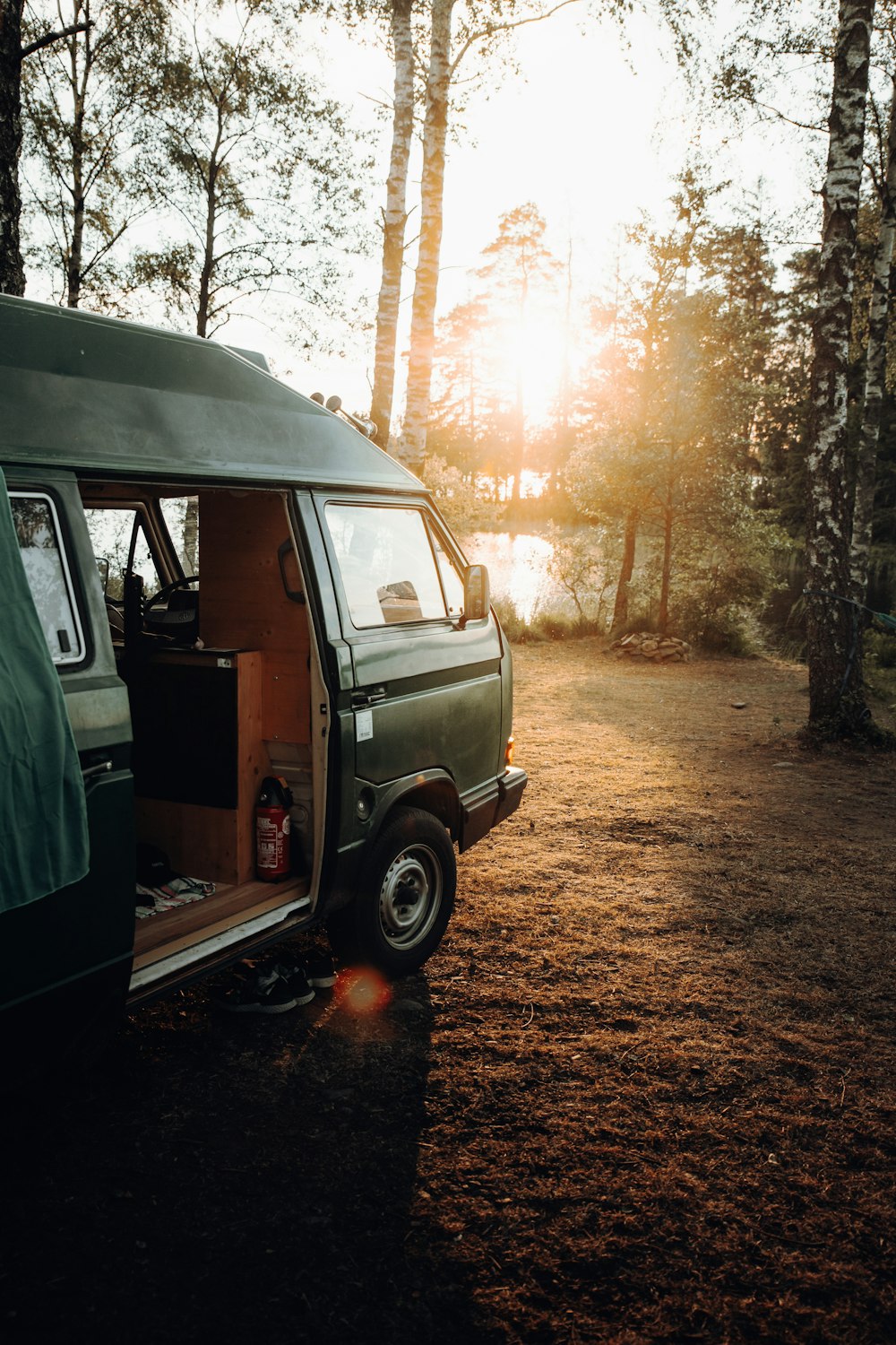 gray van parked on brown dirt road during daytime