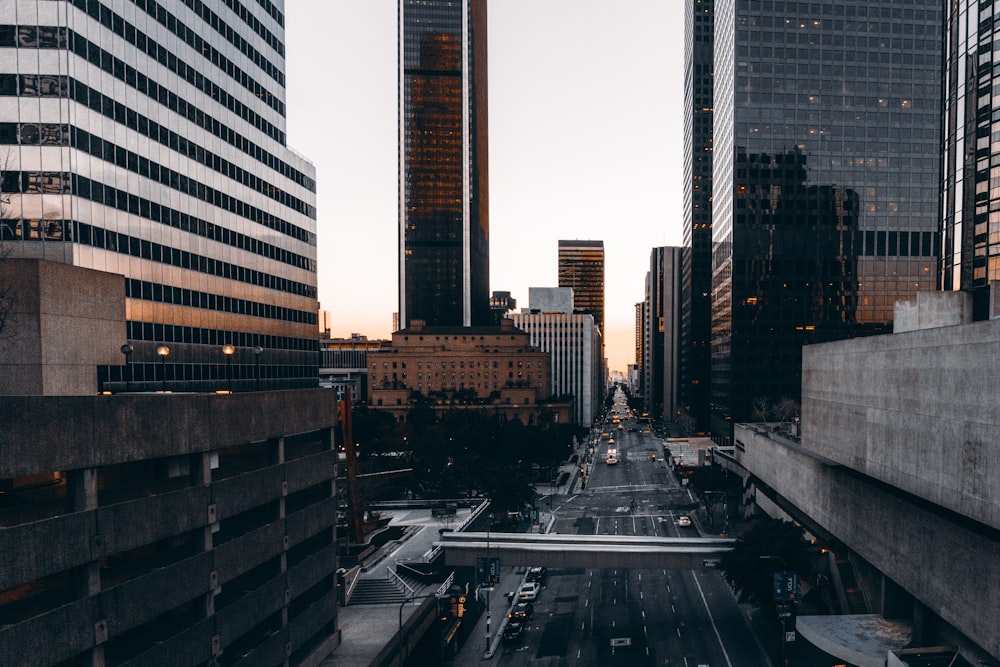 cars on road near high rise buildings during daytime