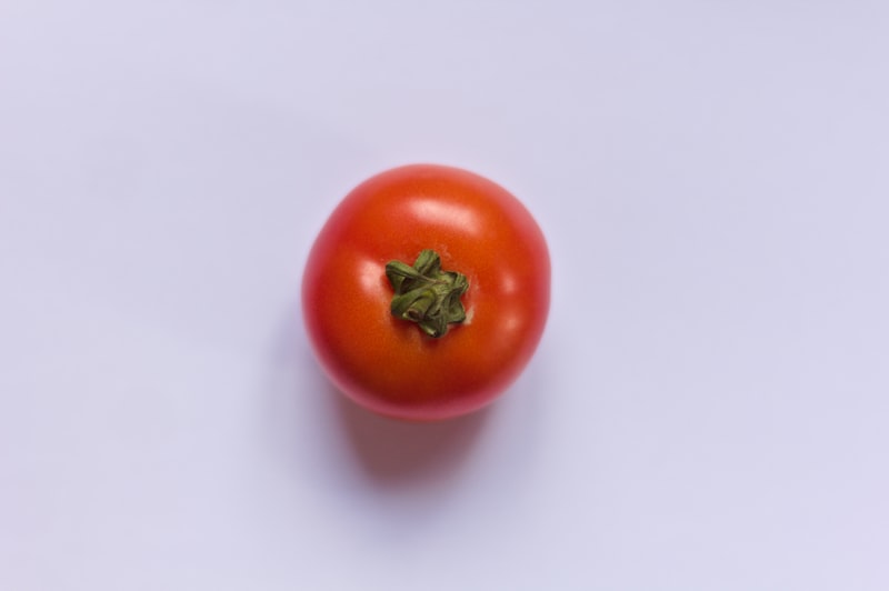 red tomato on white table