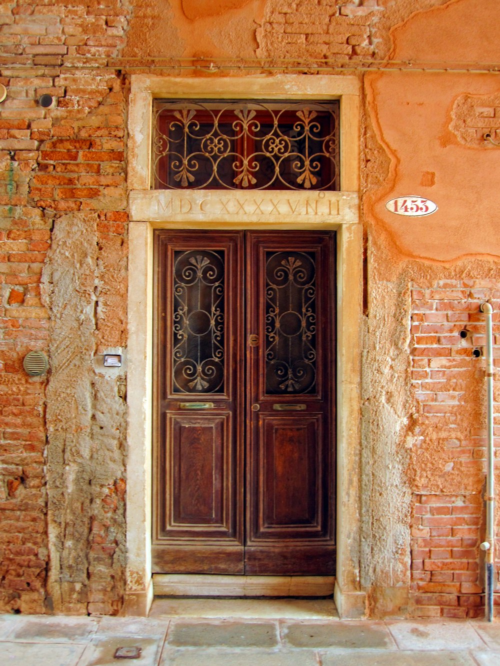 brown wooden door on brown brick wall