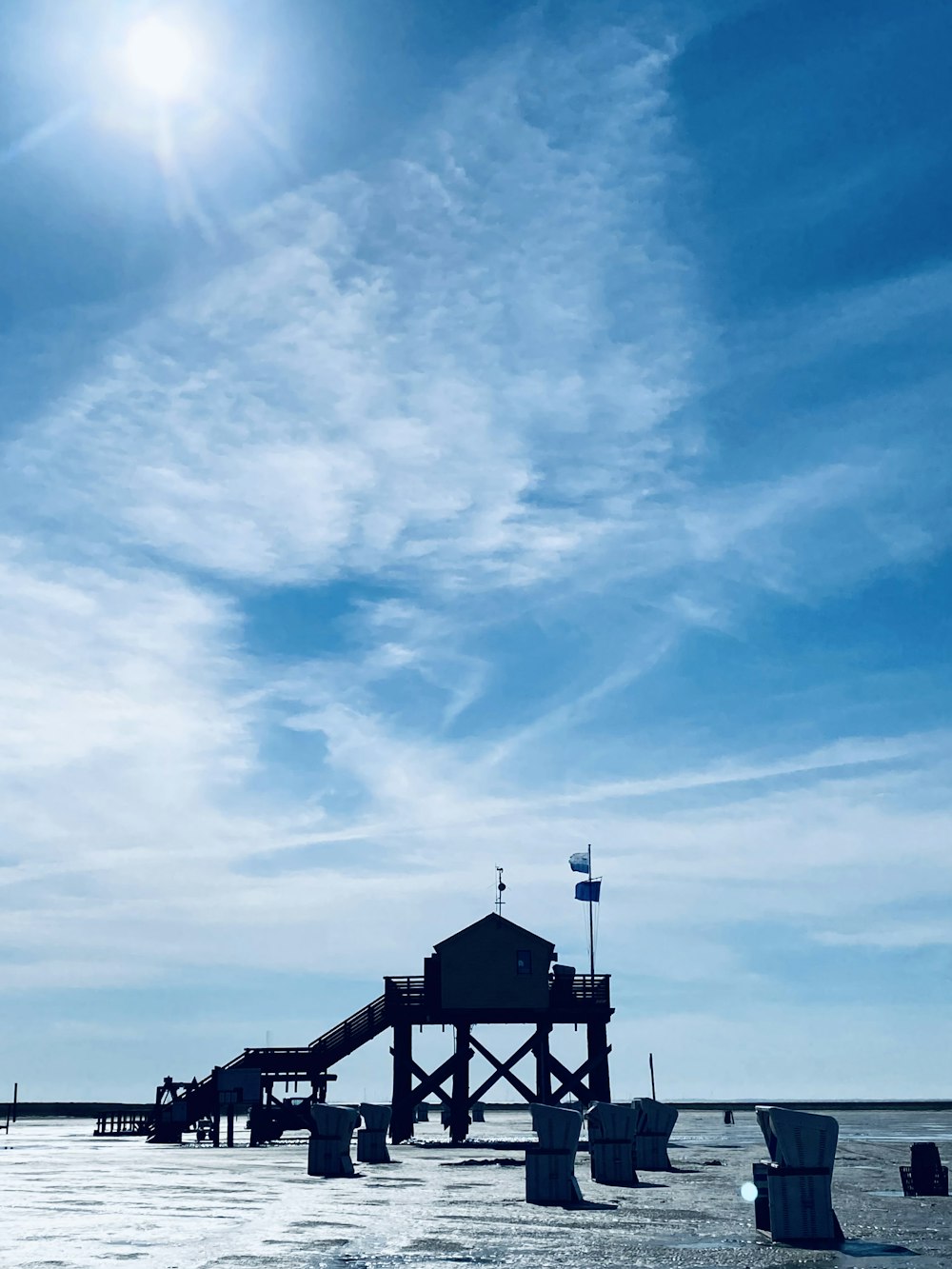 silhouette of building under blue sky and white clouds during daytime