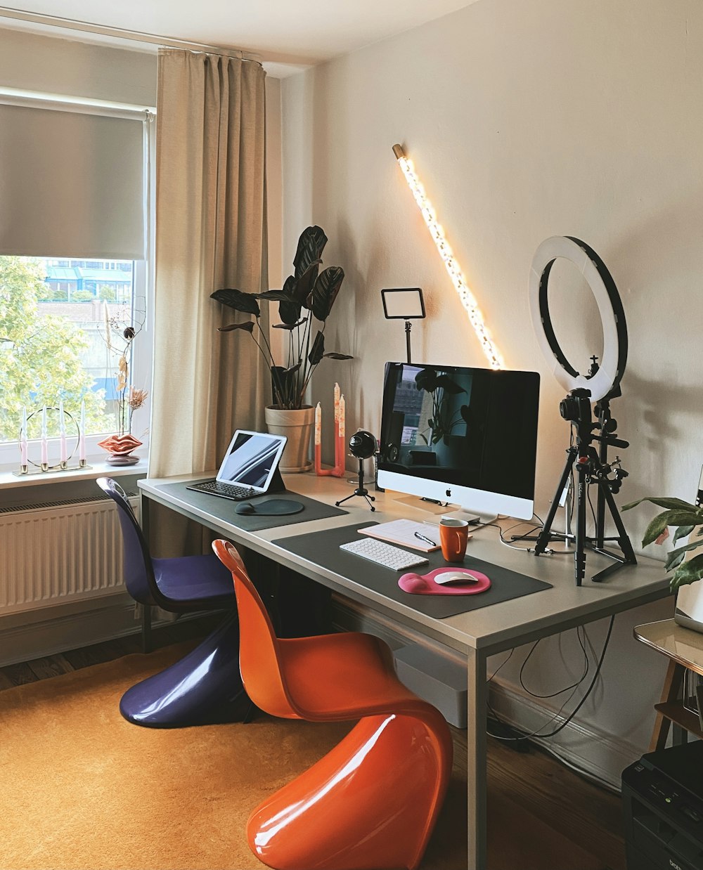 a desk with a computer and a laptop on it