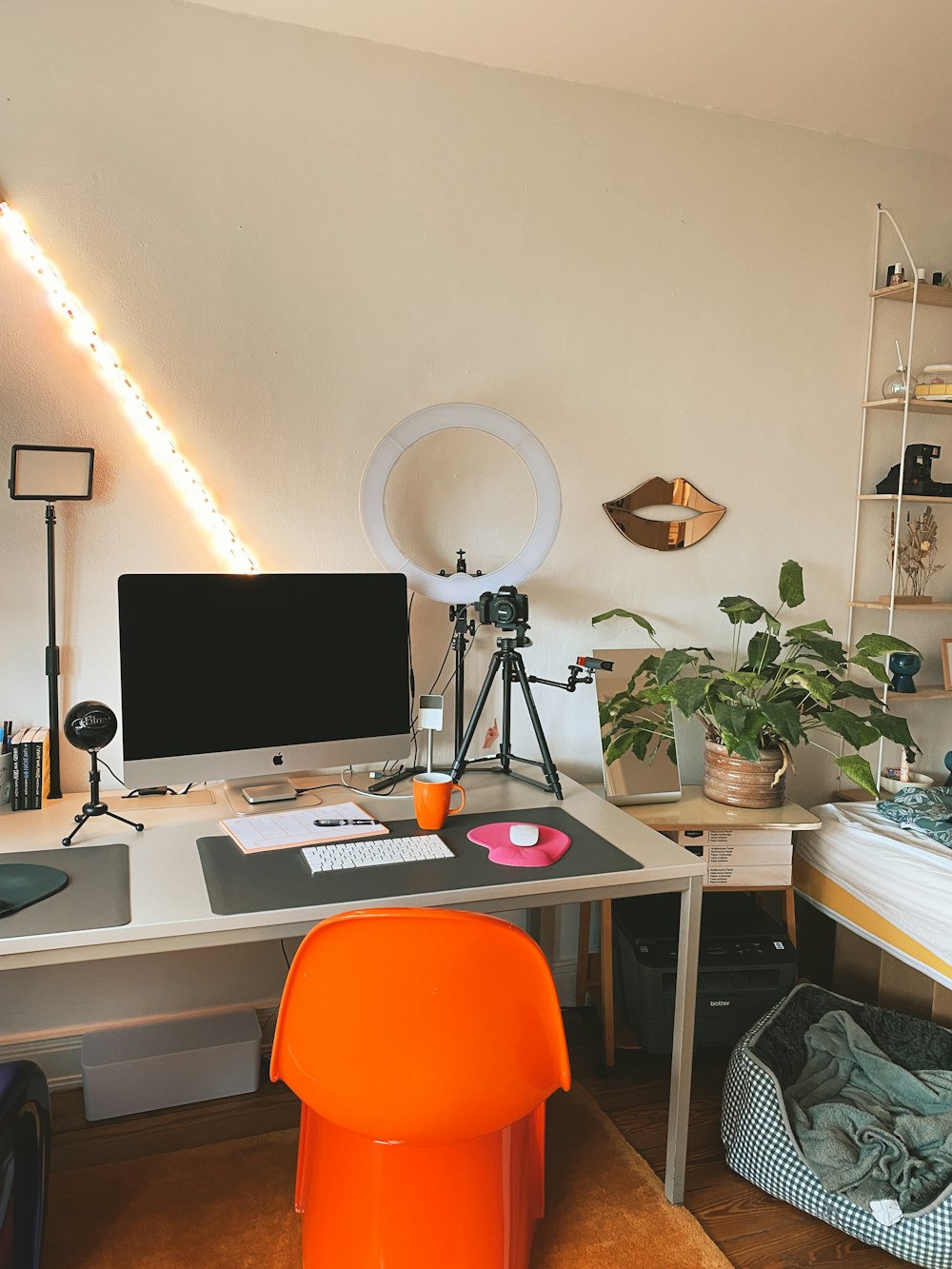 a desk with a computer and a chair