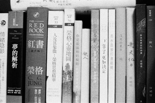 white and black book on white wooden shelf