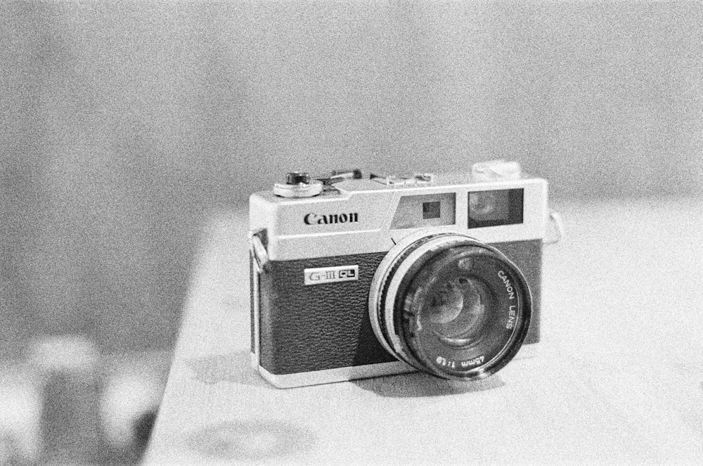 black and silver camera on white table