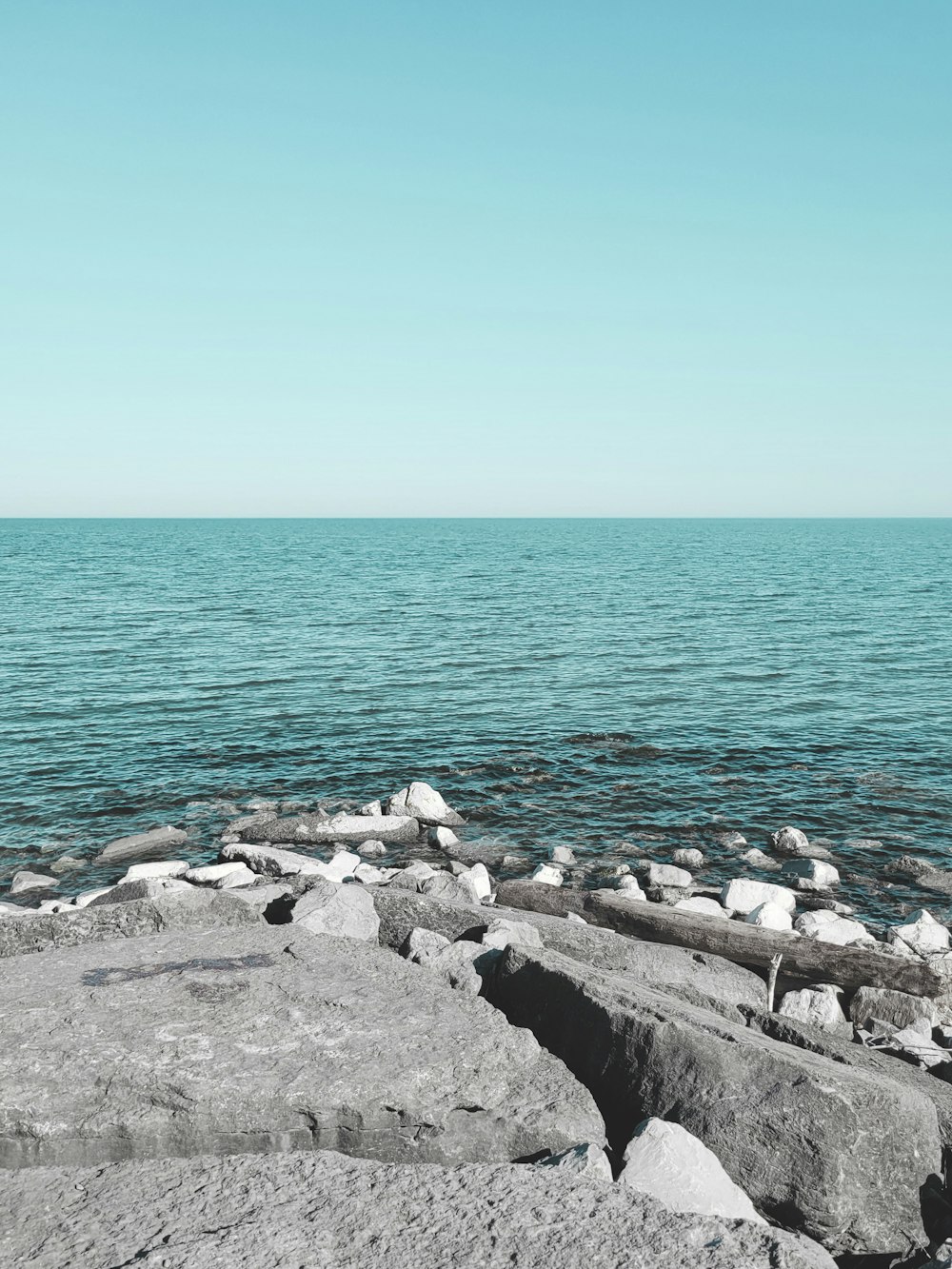 gray rocks near body of water during daytime