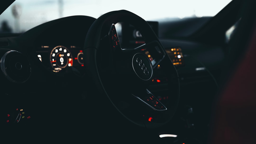 black car steering wheel during daytime