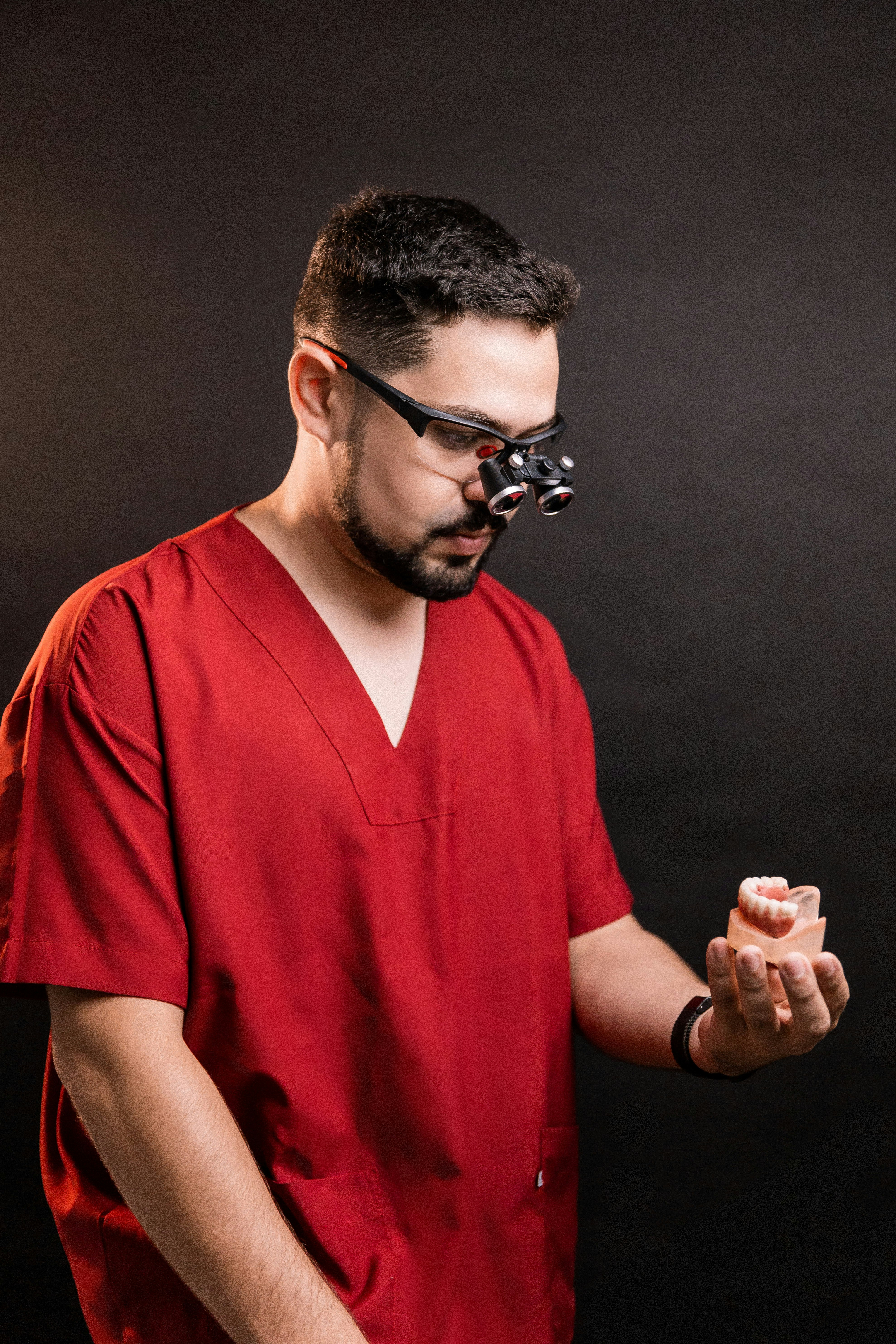 man in red polo shirt wearing black sunglasses