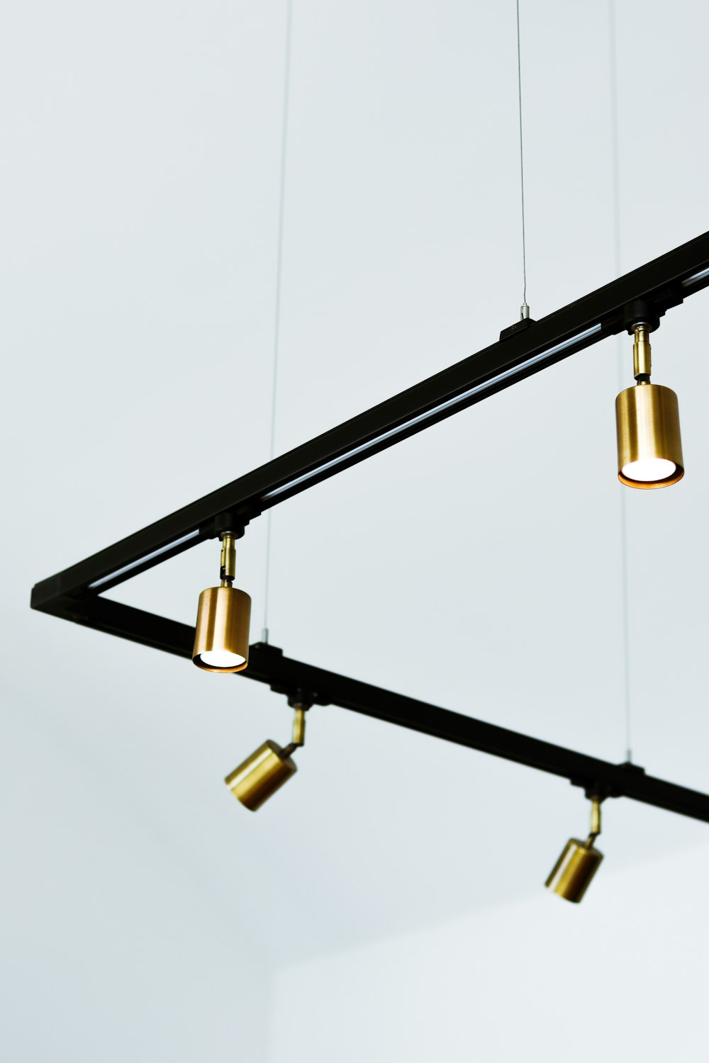 black metal frame with brass light bulb