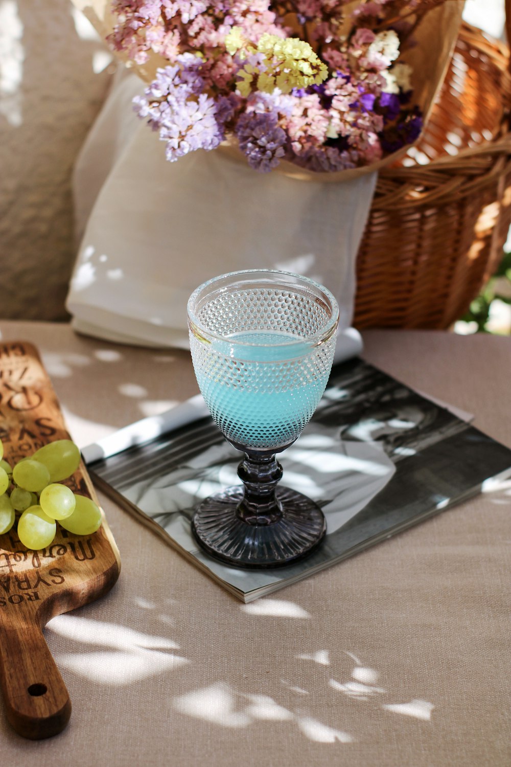 blue and white footed glass on black coaster