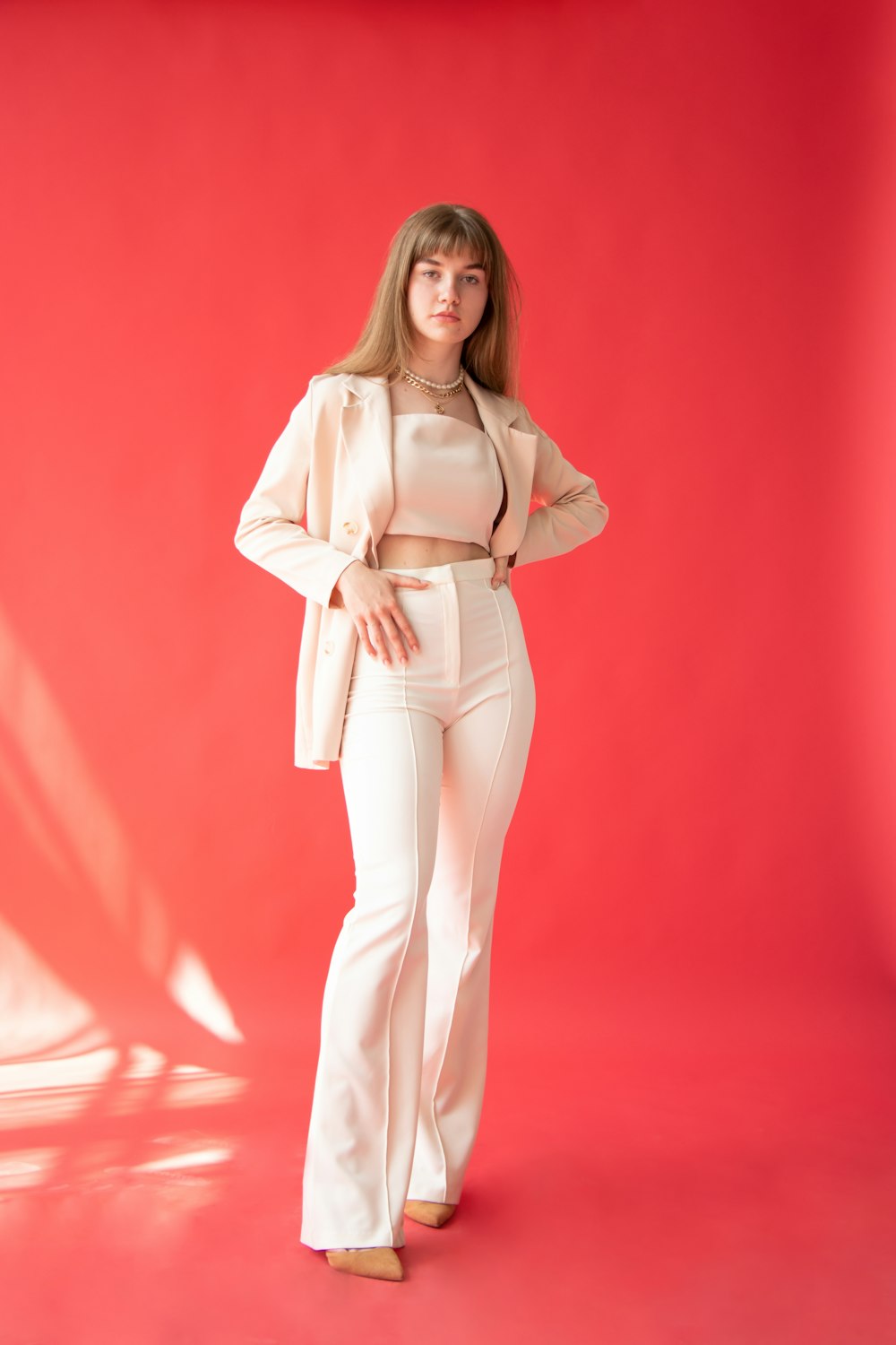 woman in white long sleeve shirt and white pants standing