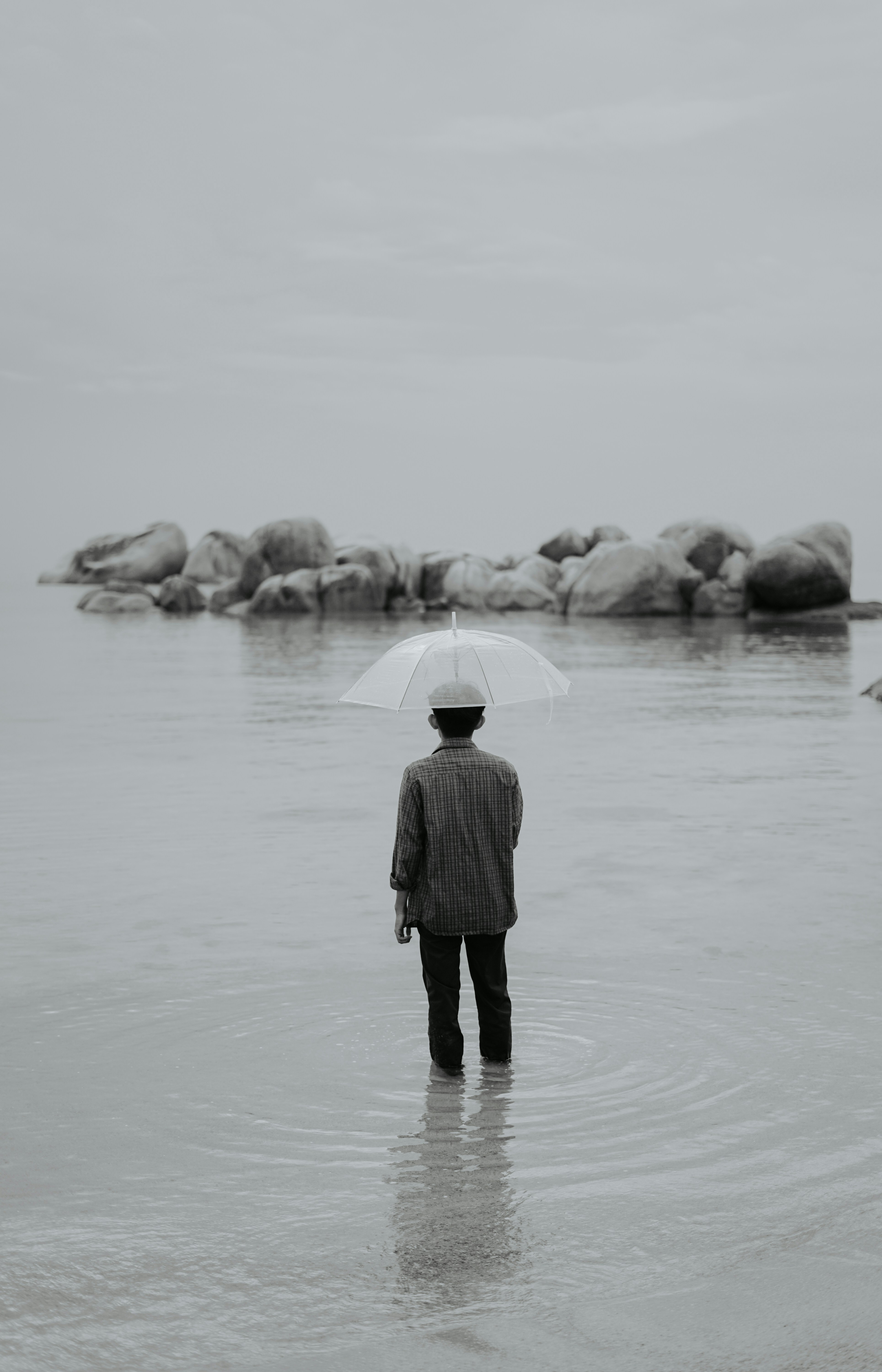 woman in black coat standing on snow covered ground during daytime