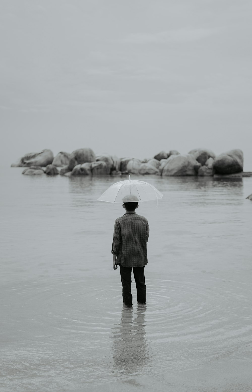 woman in black coat standing on snow covered ground during daytime