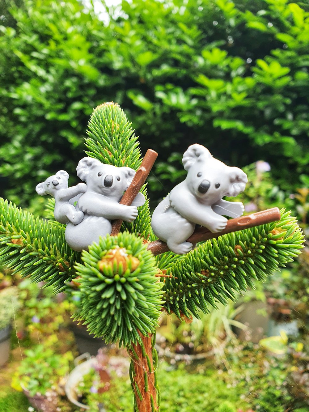 white dog ceramic figurine on green pine tree