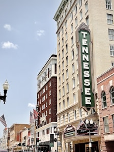 brown concrete building with green and white signage
