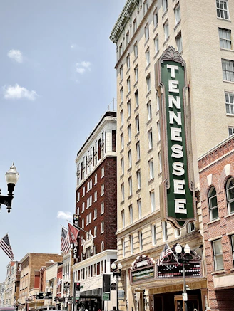 brown concrete building with green and white signage