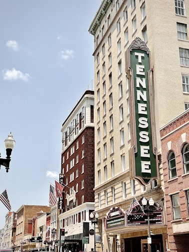 brown concrete building with green and white signage