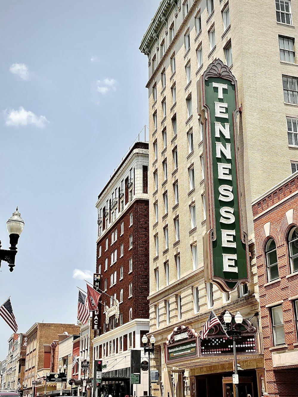 brown concrete building with green and white signage