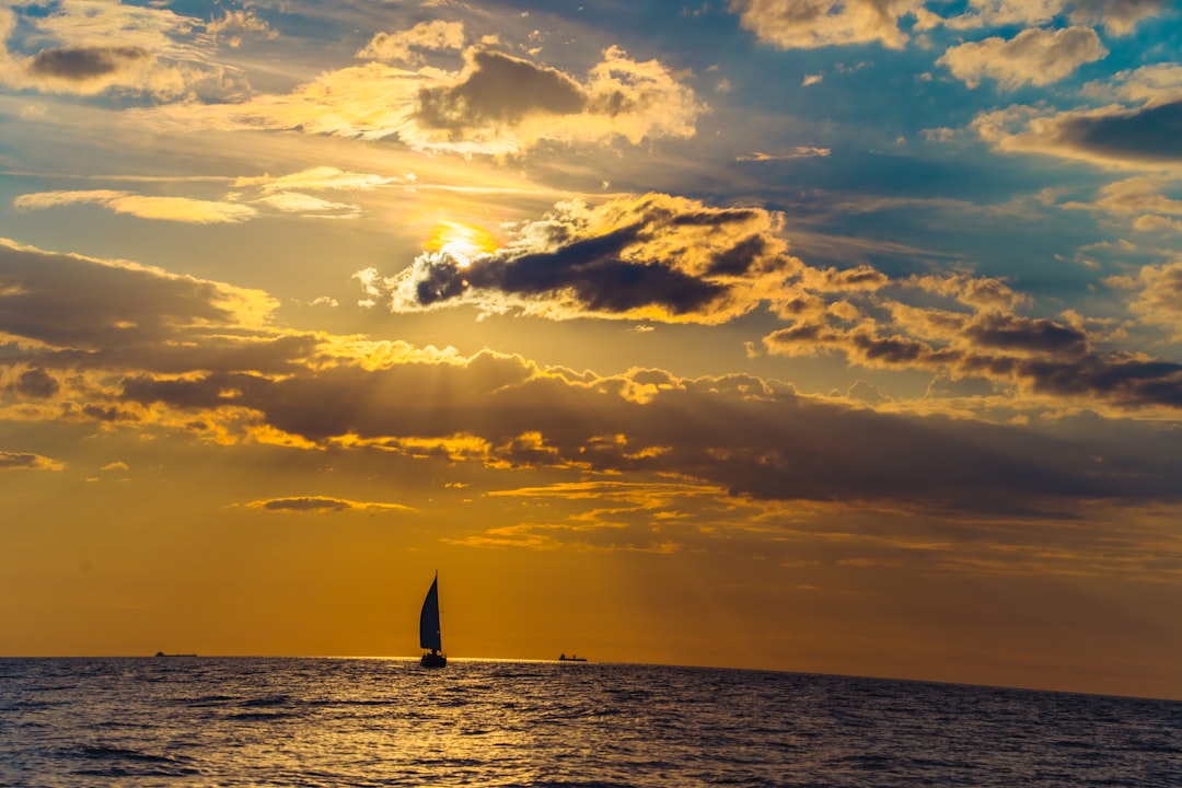 sailboat on sea during sunset